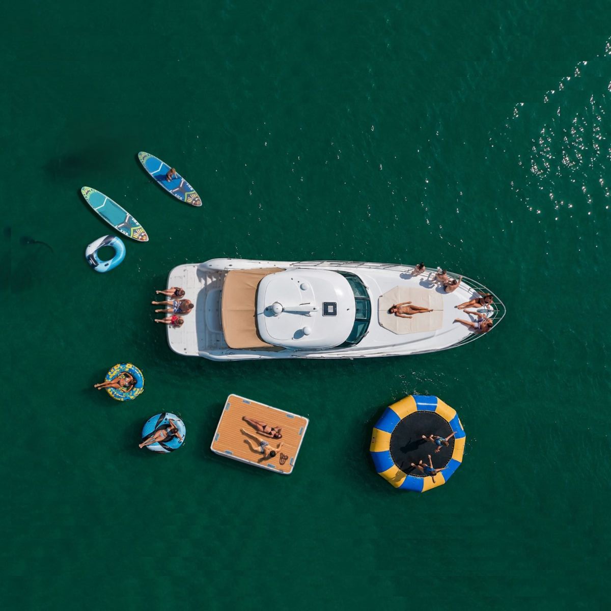 Aerial view of luxury yacht with water toys in turquoise water